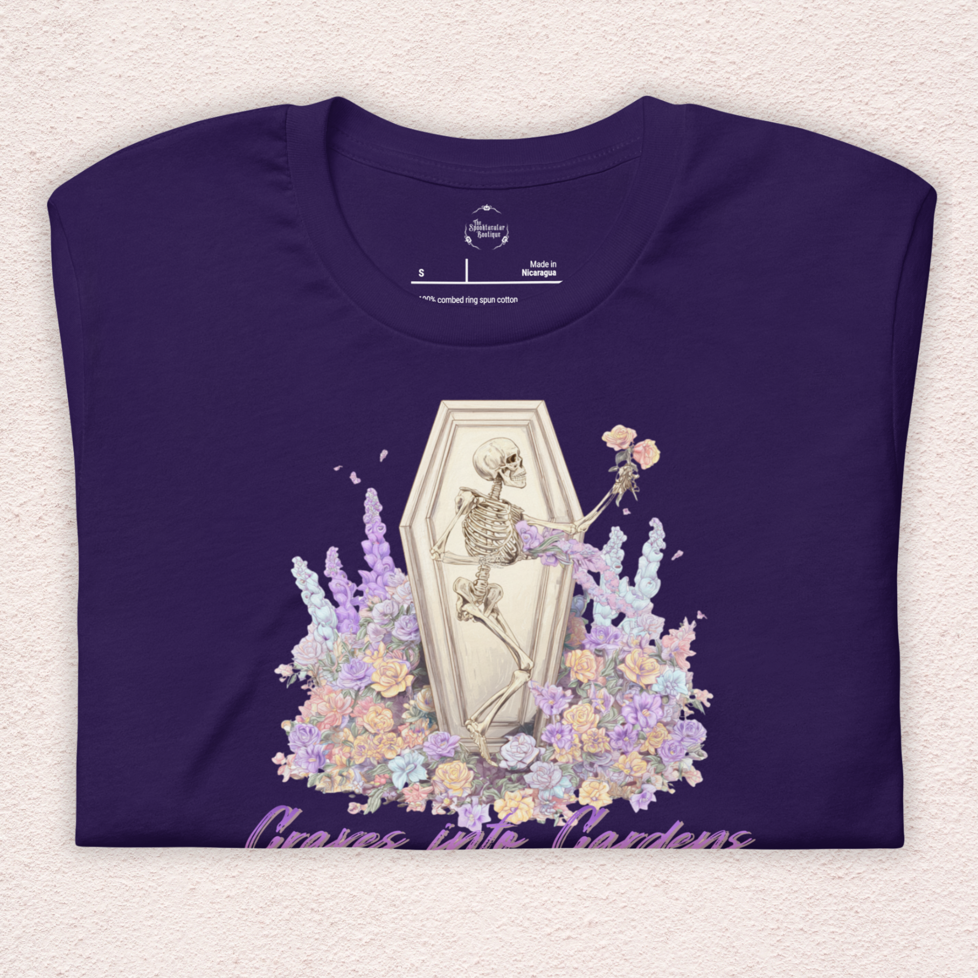 Graves Into Gardens Skeleton Easter Tee | Gothic Faith Spring Shirt | Pastel Floral Resurrection Graphic | Spooky Christian Bella Canvas T-Shirt