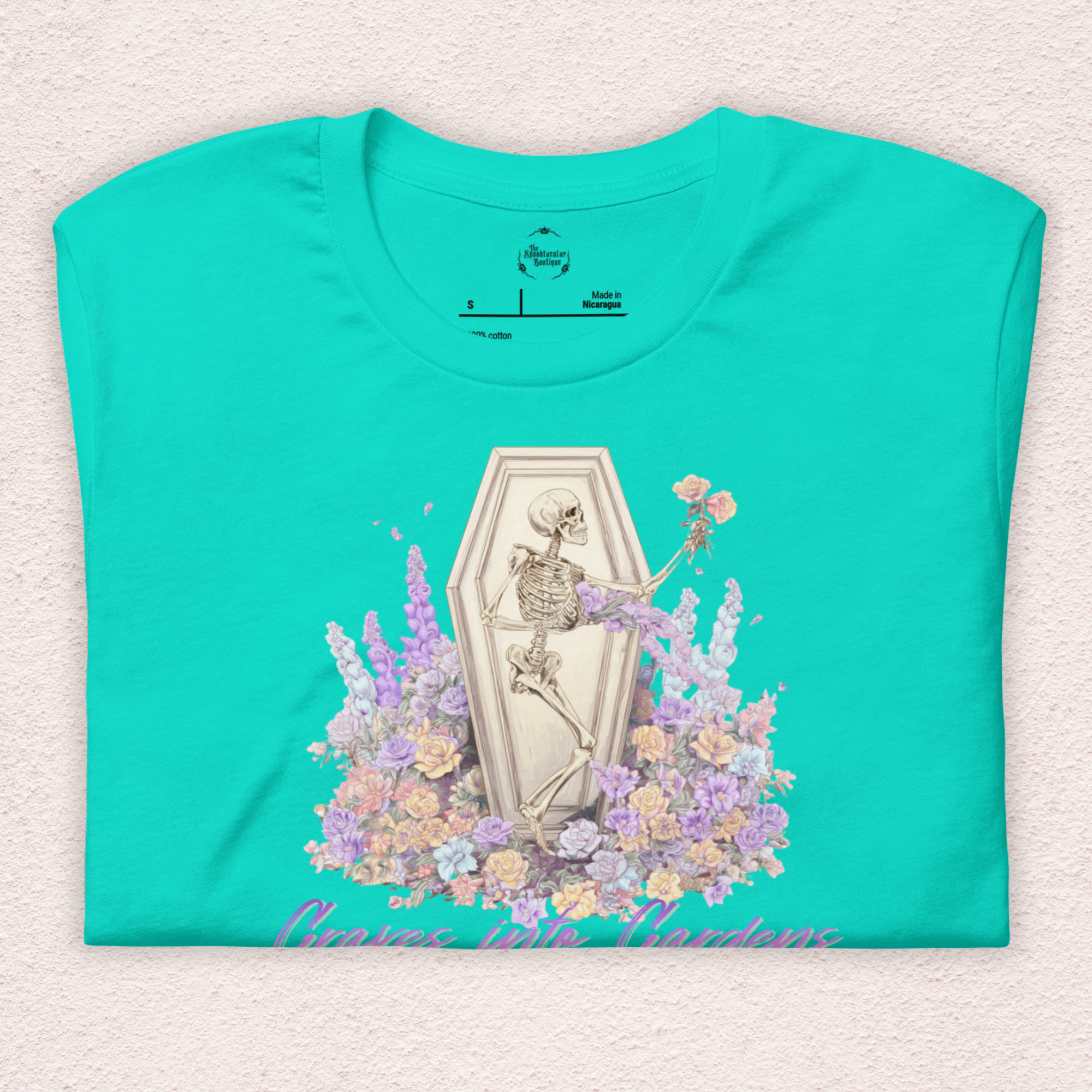 Graves Into Gardens Skeleton Easter Tee | Gothic Faith Spring Shirt | Pastel Floral Resurrection Graphic | Spooky Christian Bella Canvas T-Shirt