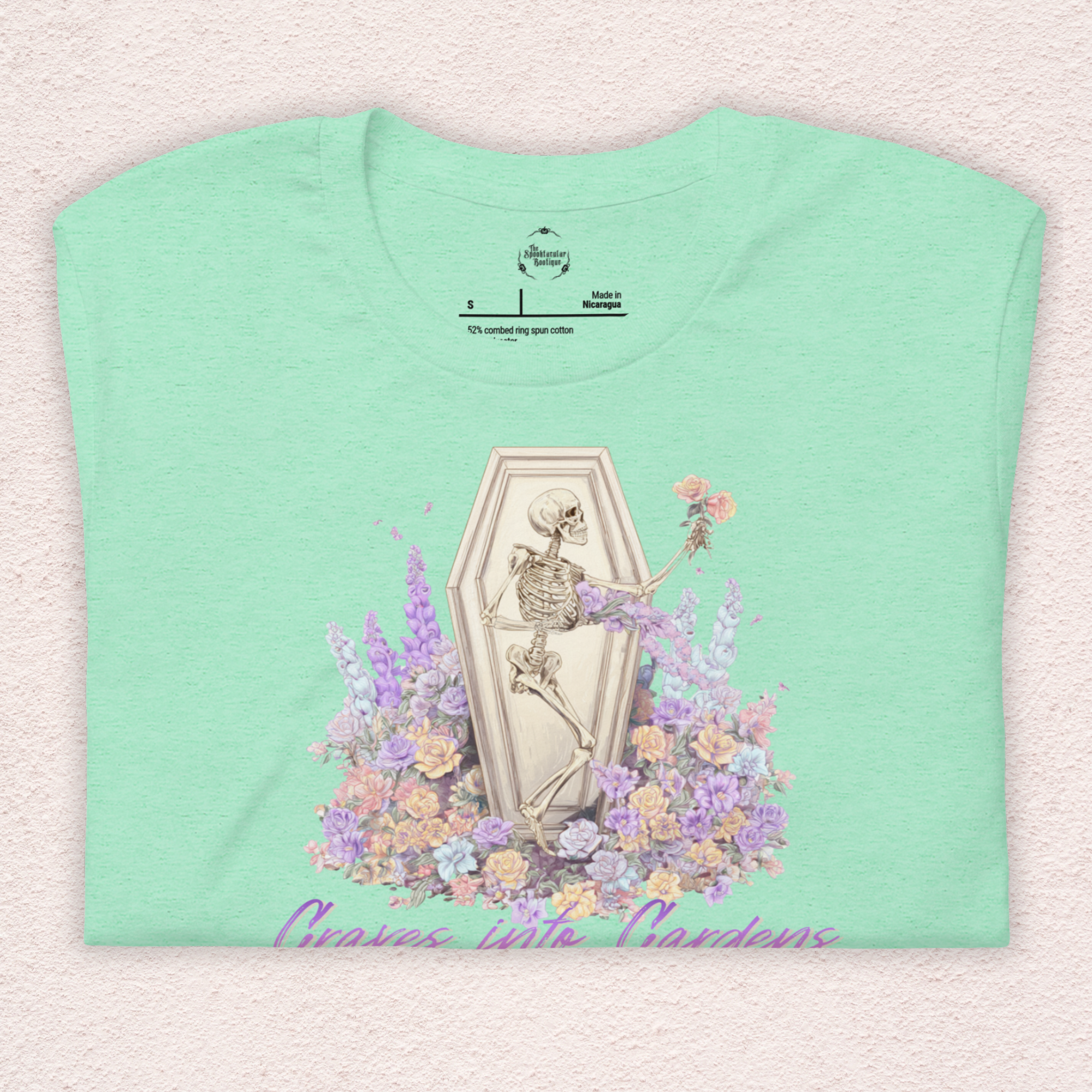 Graves Into Gardens Skeleton Easter Tee | Gothic Faith Spring Shirt | Pastel Floral Resurrection Graphic | Spooky Christian Bella Canvas T-Shirt