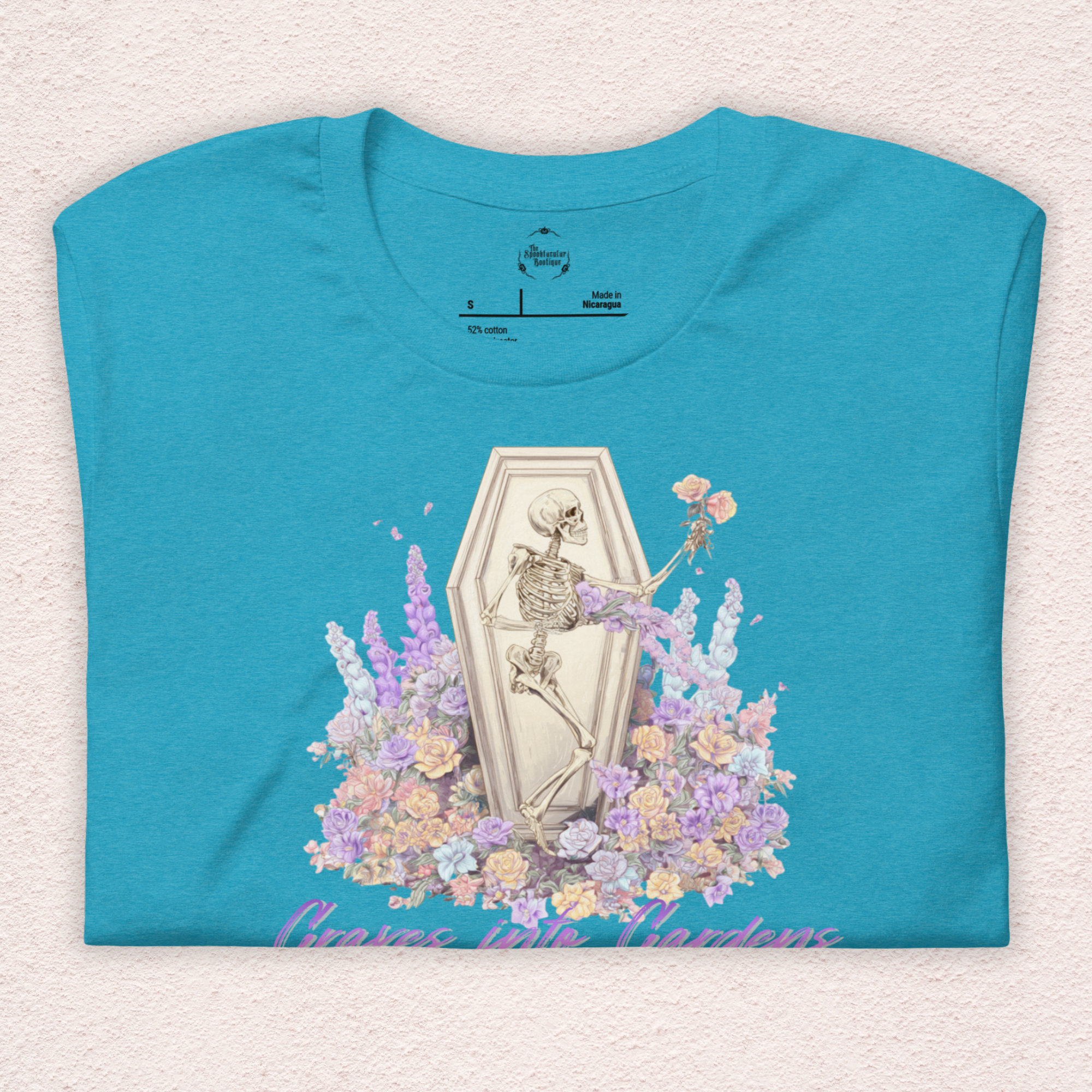 Graves Into Gardens Skeleton Easter Tee | Gothic Faith Spring Shirt | Pastel Floral Resurrection Graphic | Spooky Christian Bella Canvas T-Shirt